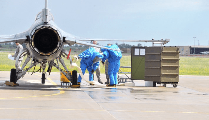 Members of a Hydrazine Response Team Use Protection to Prevent a Simulated Hydrazine Leak From Spreading