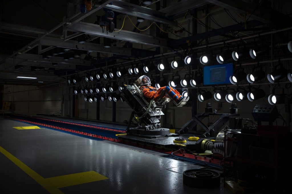 A U.S. Air Force volunteer tests the next replica of a seat and flight suit for the Orion space capsule