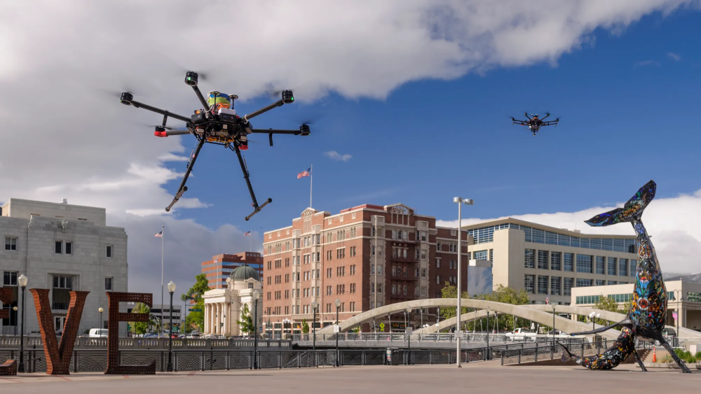 Two unmanned drones flying close to ground level.