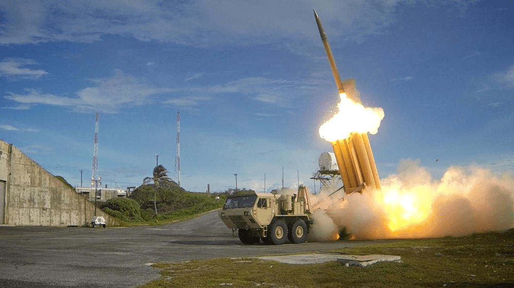 Missile being launched vertically from the back of a military vehicle.