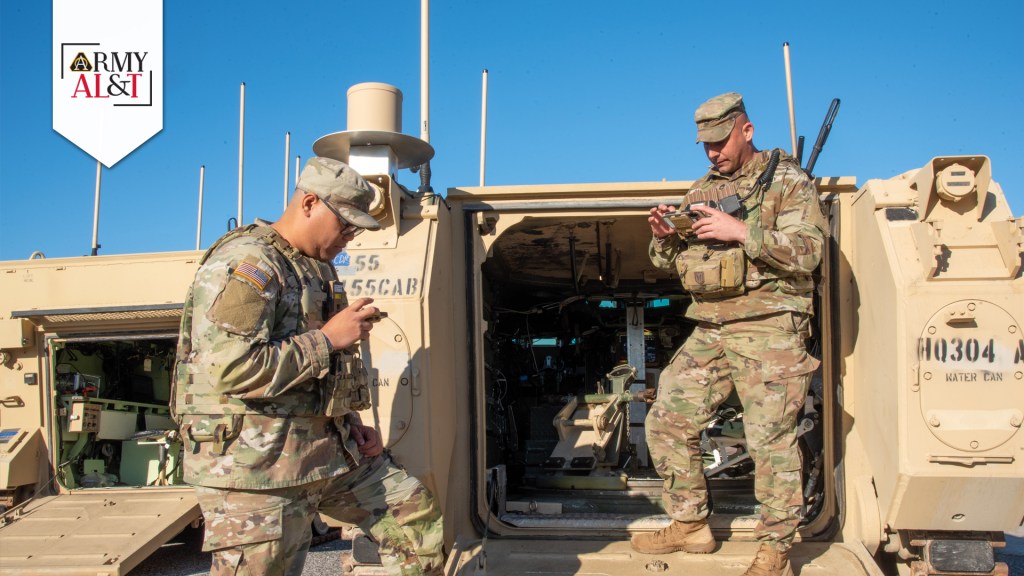 soldiers standing near tactical vehicle