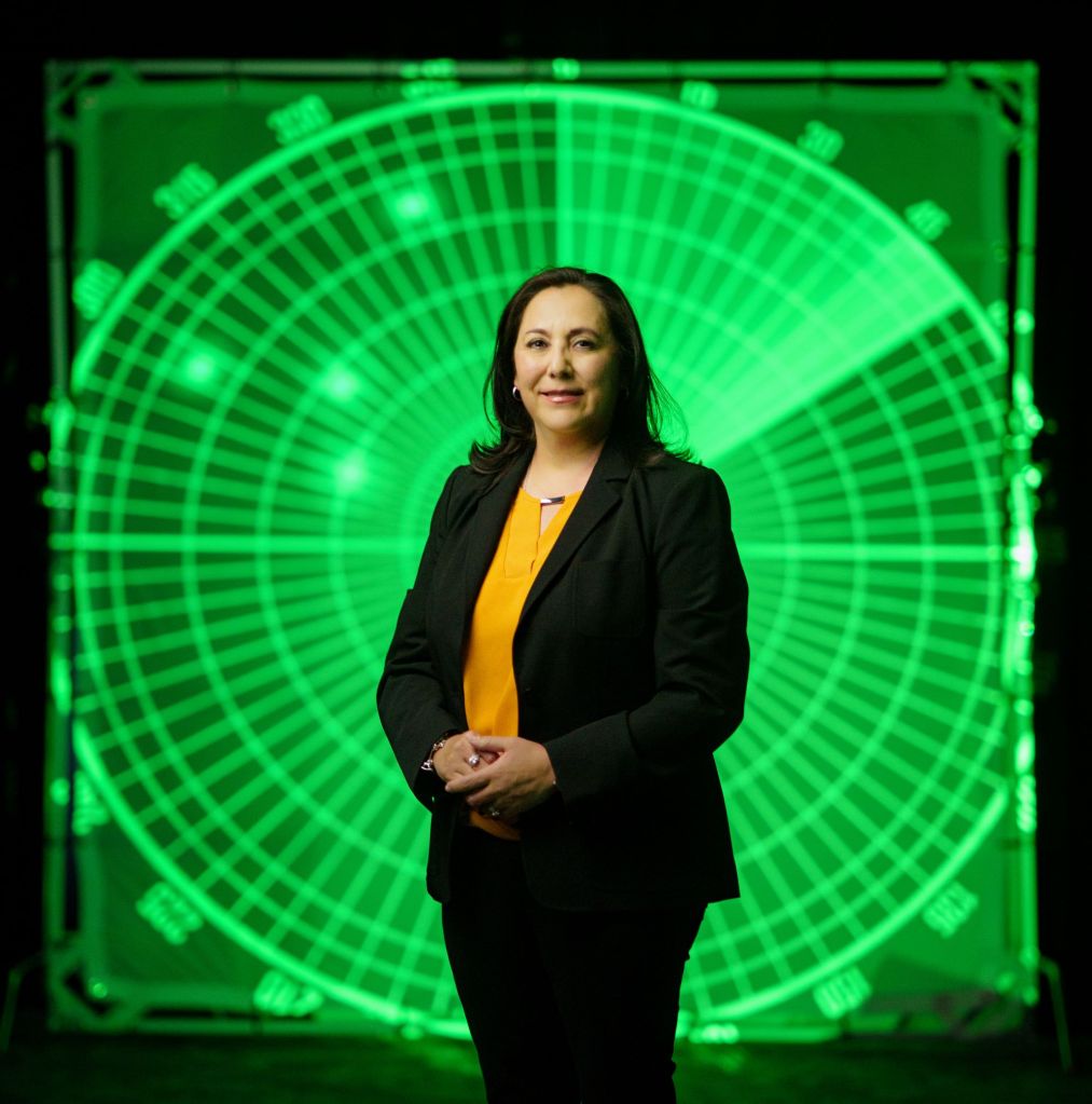 woman standing in front of radar screen