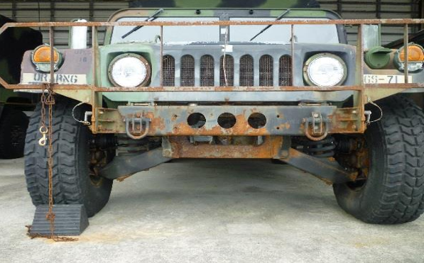 A rusted and corroded military ground vehicle is shown