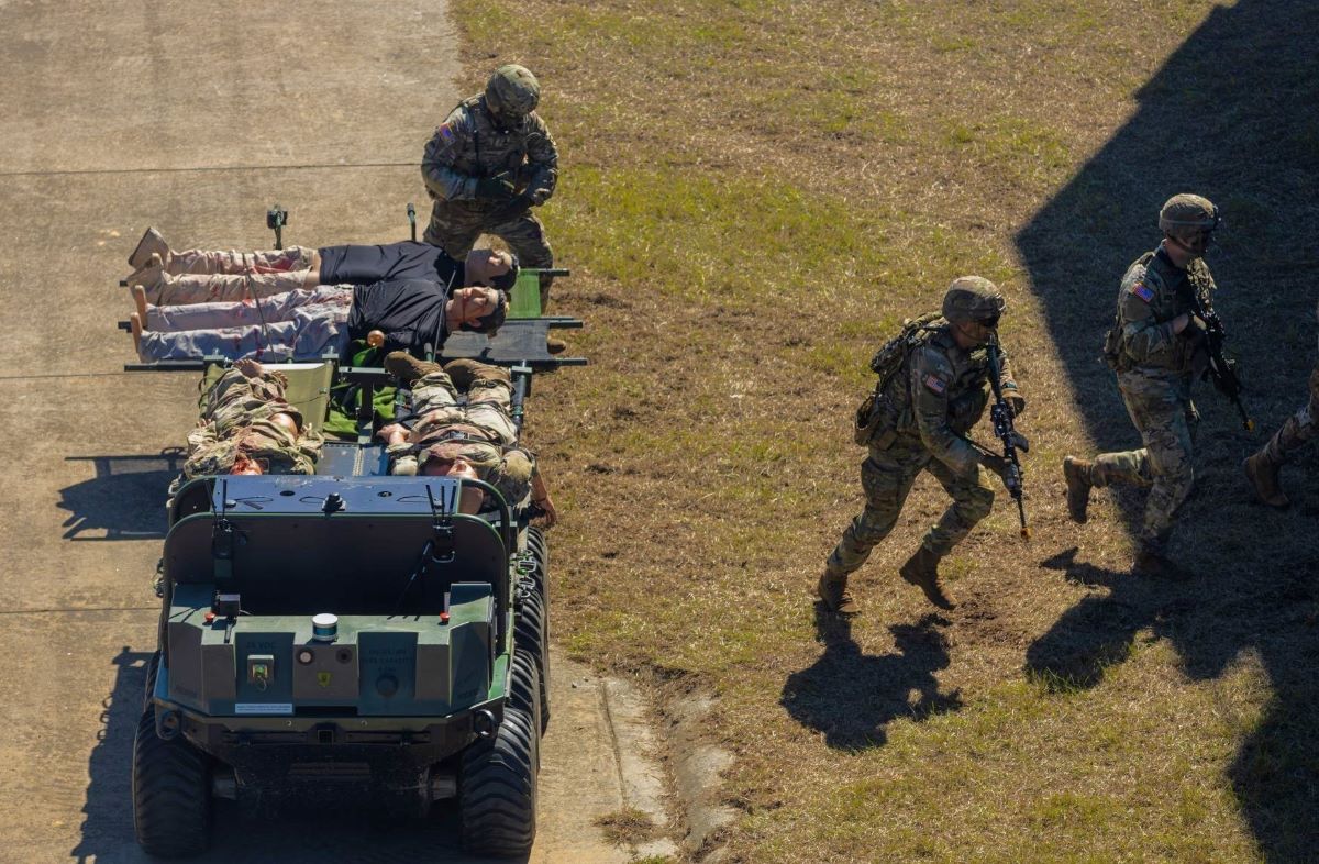 Soldiers of the Maneuver Center of Excellence Experimental Company, 1st Battalion, 29 Infantry Regiment, 316th Cavalry Brigade, employ integrated robotics during a simulated operation as attendees of the Human Machine Integration Summit II view the action, Oct. 17, 2023, at Fort Moore, Ga. The Army has been working with prototypes and performing exercises with new technology including robotic combat vehicles, or RCVs, to help achieve the Secretary of the Army’s goal of “no blood for first contact,” where human machine integrated formations shoulder risk normally assumed by Soldiers. (U.S. Army photo by Denise Mosley)