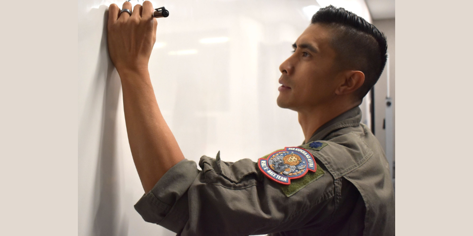 U.S. Air Force Lt. Col. Jason “J.U.” Utulo, Director of Operations Experimentation, writes on a white board during the National Space Defense Center Advanced Concept Experimentation (NACE) events at Schriever Space Force Base, Colo., Oct. 10, 2024. The NACE program’s mission is to rapidly iterate and improve space superiority, Intelligence Surveillance and Reconnaissance, and defensive cyber command-and-control processes and procedures. NACE is the NSDC’s operationally and tactically focused venue to rapidly improve its ability to execute assigned missions through experimentation, utilizing space warfighters in live-ops and tabletop exercises using current and near-operational capabilities. (U.S. Space Force photo by Bridget Bonnette)