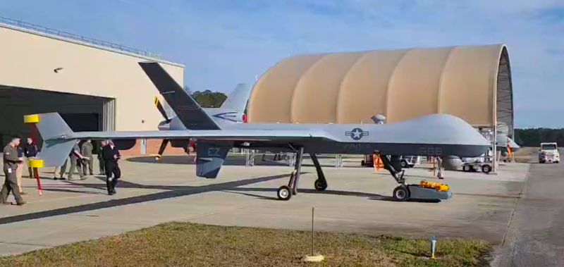 Marines test the TowFLEXX TF-3 Milspec, a new aircraft tug capability, with the MQ-9A Reaper at Marine Corps Air Station Cherry Point in March 2025. The TowFLEXX allows a single operator to maneuver military aircraft with unprecedented precision, maintaining the aircraft's nose wheel alignment while enabling 360-degree turns in confined spaces. (U.S. Navy photo)