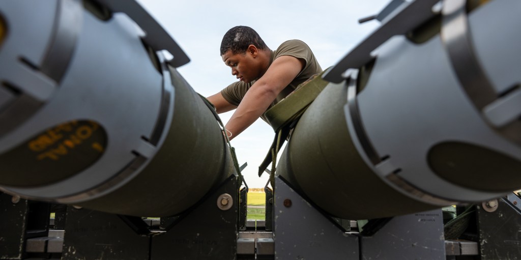 An Airman assigned to the 393rd Bomber Generation Squadron prepares GBU-38 Joint Direct Attack Munitions to be loaded onto a B-2 Spirit stealth bomber at Whiteman Air Force Base, Mo. The loading operations were a component of the Air Force Research Laboratory QUICKSINK Joint Capability Technology Demonstration, a new low-cost, air-delivered capability for defeating maritime threats. (U.S. Air Force photo by Senior Airman Joshua Hastings)