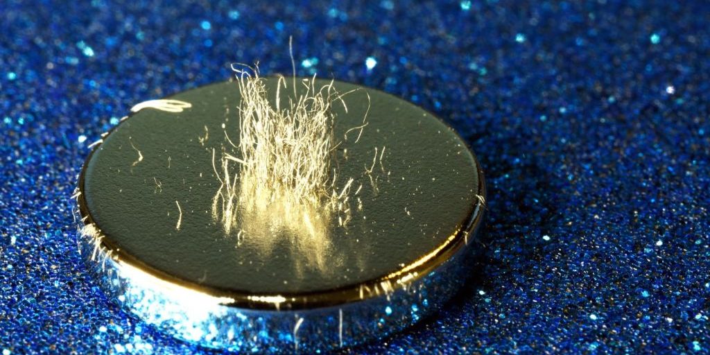 Metal shavings stand vertically atop a rare earth magnet.