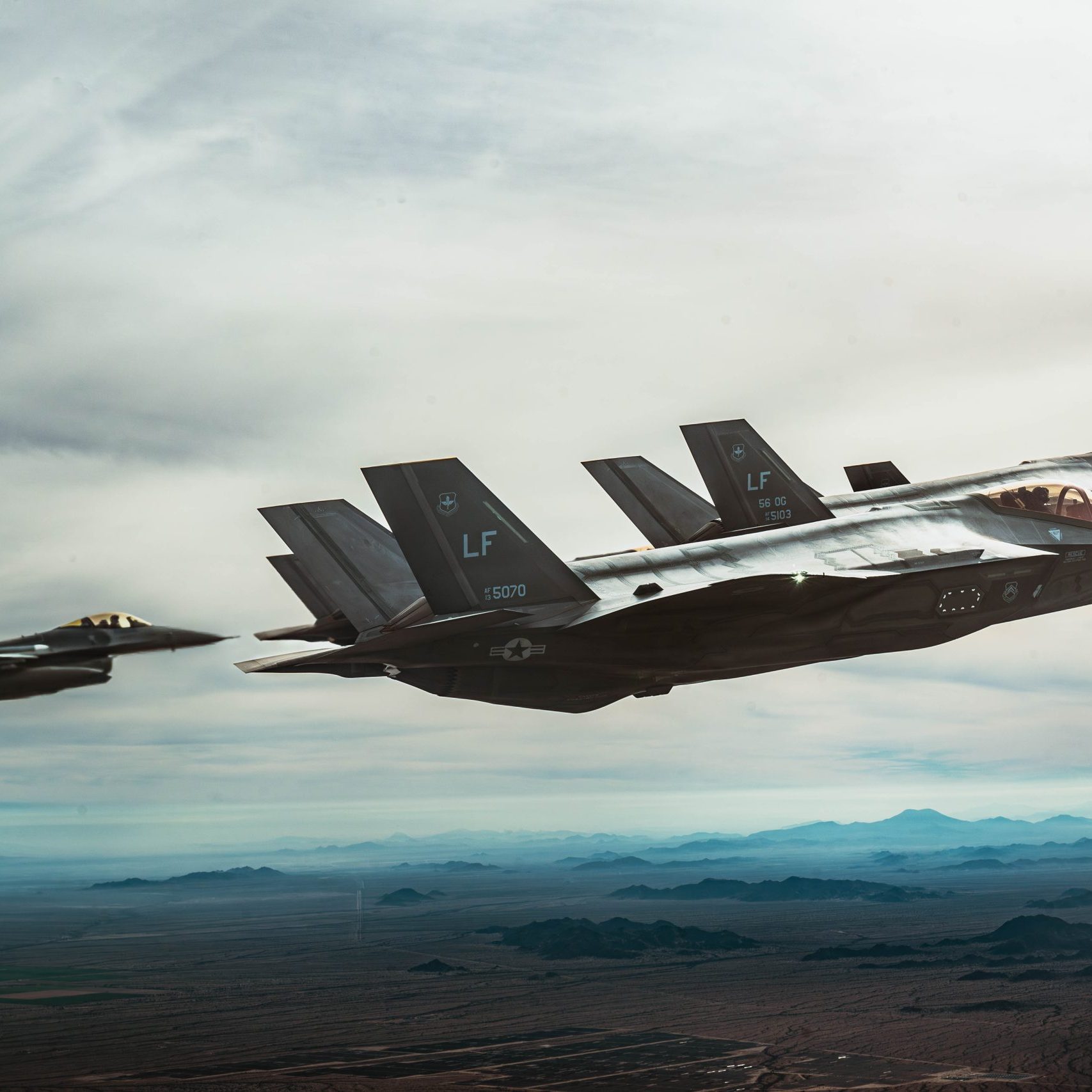 USAF F-35A Lightning II’s and an F-16 Fighting Falcon aircraft fly in formation