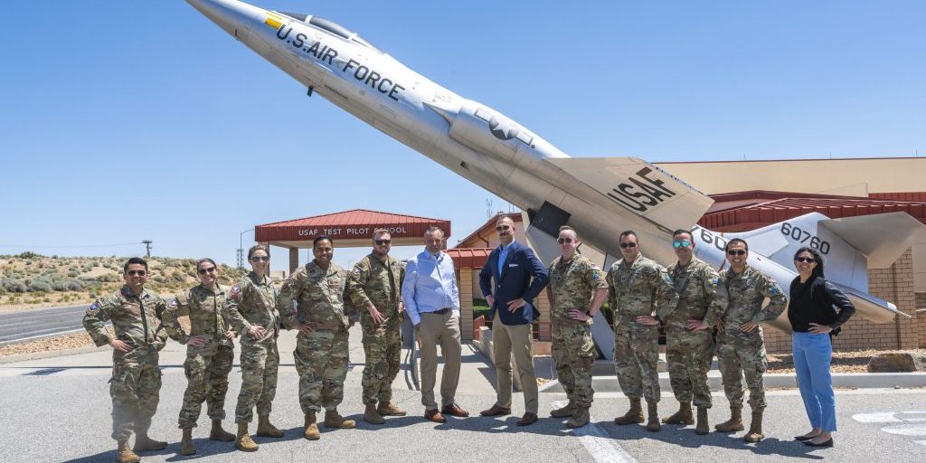 Space Test Course Class 24A at the U.S. Air Force Test Pilot School standing in front of a plane