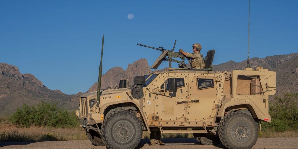 U.S. Army indirect-fire infantryman, Spc. Andrew Wilson assigned to Headquarters and Headquarters Company, 2nd Battalion, 37th Armor Regiment, 1st Armored Brigade Combat, 1st Armored Division, stands by to receive ammo while in a Joint Light Tactical Vehicle (JLTV) with a mounted M2A1 .50 cal heavy machine gun in preparation to conduct Mounted Machine Gun Gunnery Table V at McGregor Range, New Mexico, Sep 19, 2024. (U.S. Army photo by Cpl. David Poleski)