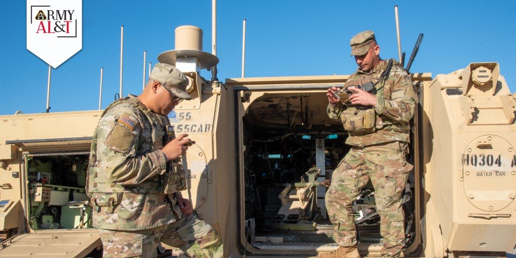 soldiers standing near tactical vehicle