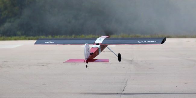 A plane marked with an AFRL logo is taking flight