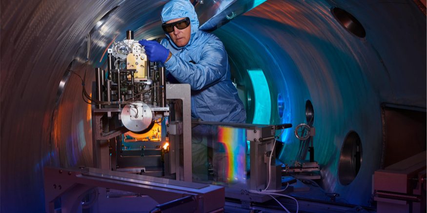 Rick Cross works on the Titan compressor system at the Jupiter Laser Facility. The gratings (rainbow reflection) allow the Titan laser to provide peak power while preserving the optical components of the system. (Photo: Garry McLeod/LLNL)