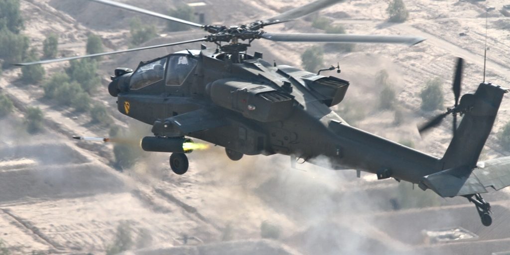 Producing a blast of smoke and fire, an AH-64D Apache attack helicopter pilot from 1st Air Cavalry Brigade, 1st Cavalry Division, fires a 2.75 inch hydra aerial folding-fin rocket while conducting a gunnery on the outskirts of Baghdad, Nov. 9. (Photo by: Chief Warrant Officer Anthony Bailey)