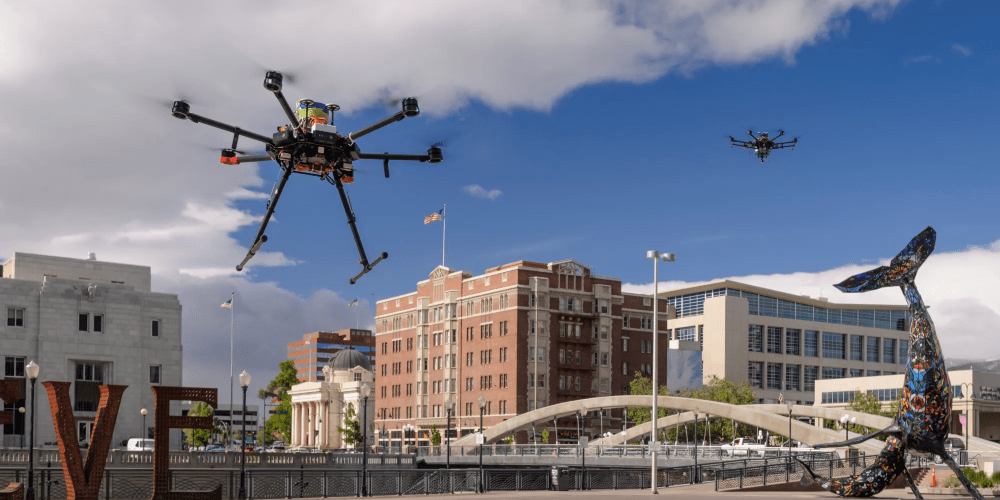 Two unmanned drones flying close to ground level.