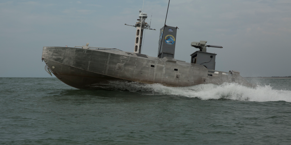 An unmanned surface vessel autonomously navigates a water bound course during a training exercise.