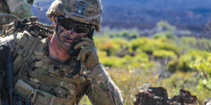 A servicemember operates communication equipment during a military exercise.