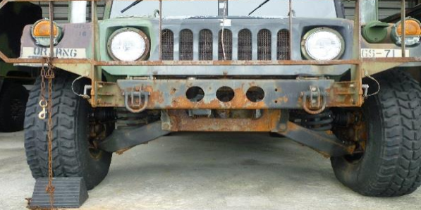 A rusted and corroded military ground vehicle is shown