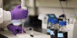 researcher using pipette in a science lab
