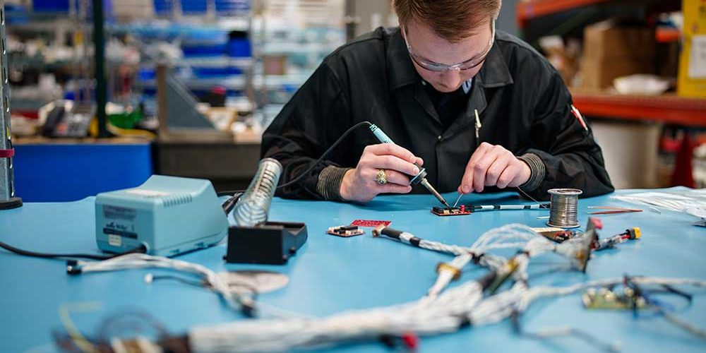 RAPID PROTOTYPING — An electrical engineer works on soldering for Core SkyFox. The project includes the use of commercial off-the-shelf parts and systems for rapid prototyping and testing of hypersonic flight testing. (Photo by Craig Fritz)